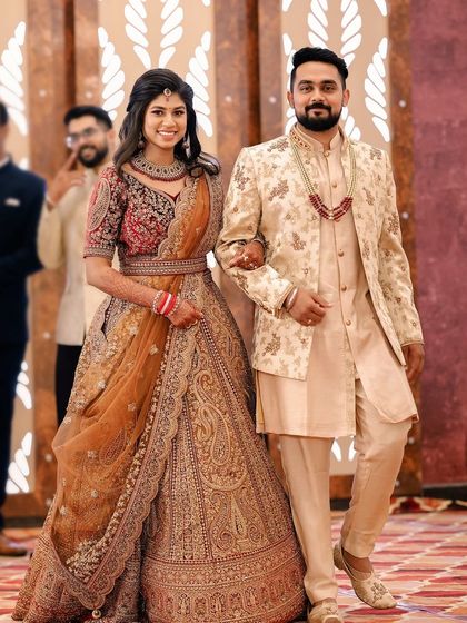 A grand entrance for the bride and groom. The bride's makeup is designed to be impactful and photograph beautifully, even from a distance.