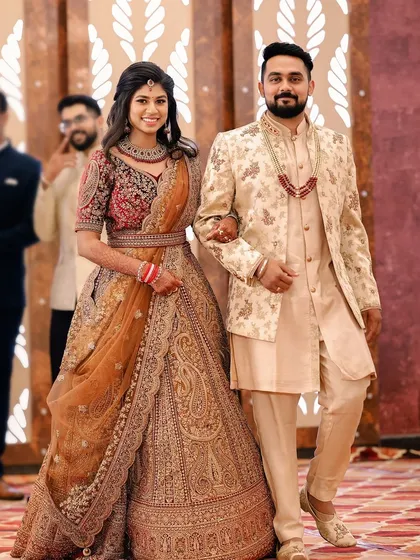 A grand entrance for the bride and groom. The bride's makeup is designed to be impactful and photograph beautifully, even from a distance.