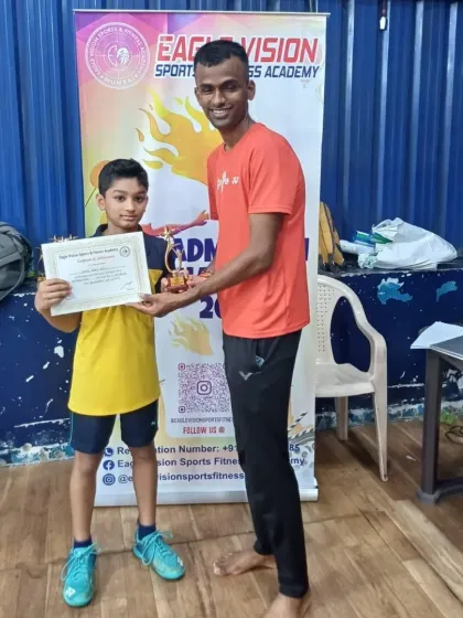 Liam Pais receiving his runner-up trophy after a hard-fought final against his twin brother.