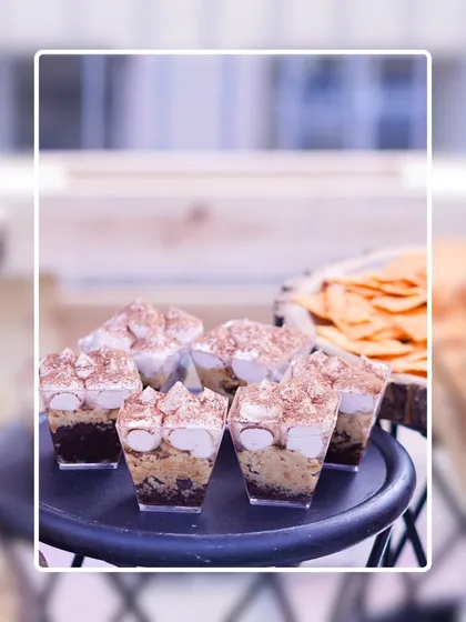 Individual Tiramisu dessert cups, layered with coffee-soaked biscuits, mascarpone cream, and a dusting of cocoa powder. A classic Italian dessert presented in a modern, convenient format.