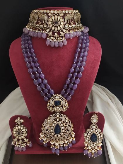 A royal-looking Victorian set in a deep lavender color. The set includes a choker and a long necklace with multiple pendants, perfect for a grand occasion.
