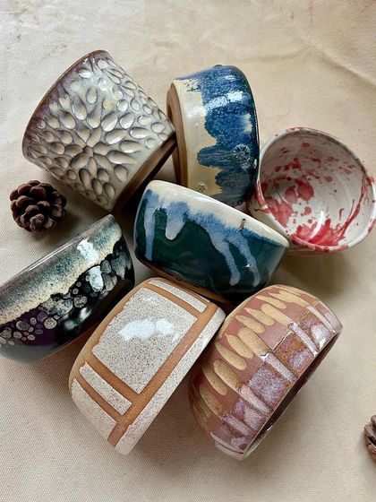 Another shot of the beautifully glazed student work. The rich colors and varied textures demonstrate the skills and creativity that blossom in our studio.