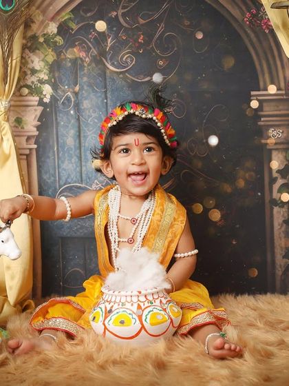 A playful moment with a pot of 'makhan'. I love capturing these interactive shots that bring the story of little Krishna to life during the photoshoot.