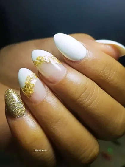 Another look at these perfect white and gold foil nails. The balance between the solid white, glitter, and foil is just so chic.