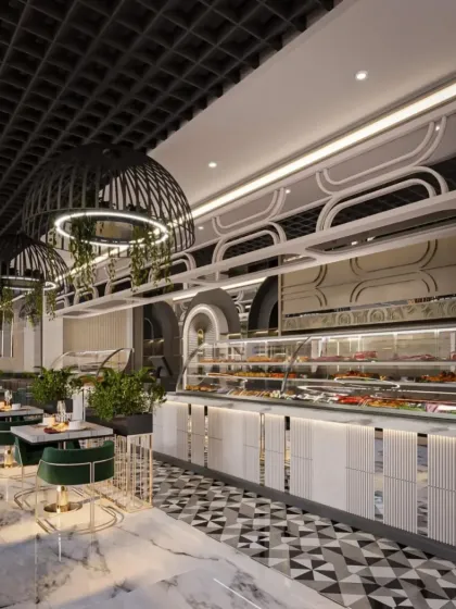 The bakery and food display counter in this restaurant is designed with intricate white paneling and geometric flooring. The hanging cage lights with greenery add a modern, industrial-chic touch to the space.