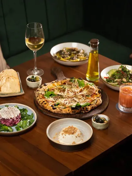 We created a dark and moody restaurant scene to showcase this Italian feast. The warm, low light creates an intimate atmosphere, making the wood-fired pizza and fresh pasta look like the perfect comforting meal.