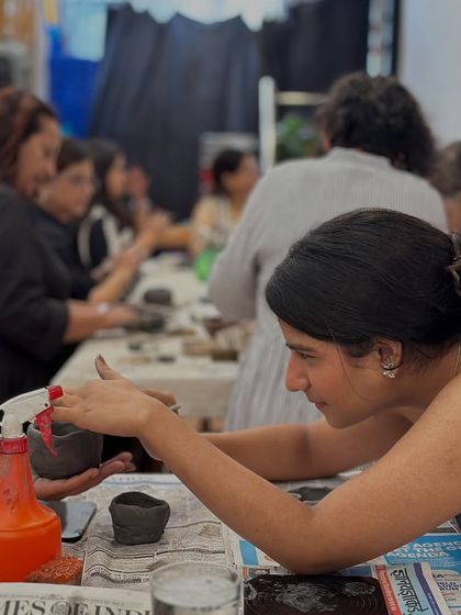 A participant carefully mists her clay bowl to keep it workable. My workshops are hands-on, and I guide everyone through each step of the process.