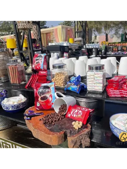 A close-up of our coffee counter setup, featuring everything needed for a perfect cup, including marshmallows, KitKats, and cinnamon sticks.