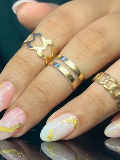 A close-up of the marble and gold foil nail art.