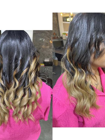 A classic blonde ombré transformation. The color smoothly transitions from a dark root to bright blonde ends, creating a timeless and glamorous look.