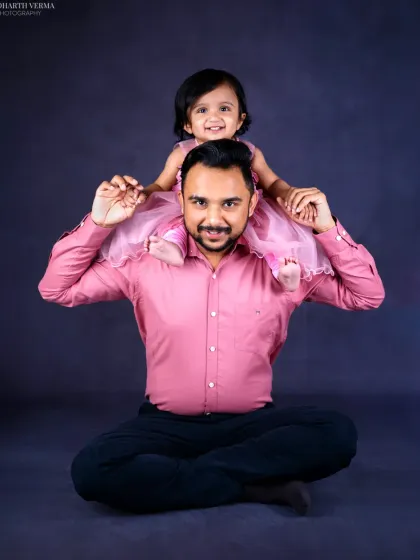 The world looks different from dad's shoulders. This playful and joyful portrait captures the special bond and pure happiness shared between a father and his little girl.