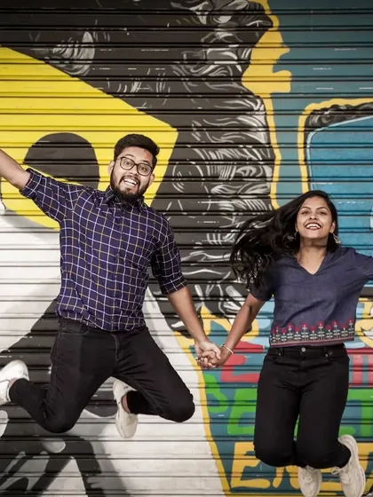 For couples who want a fun and modern vibe, I find unique spots like this graffiti wall in Delhi. This jumping shot shows a playful and energetic style of pre-wedding photography.