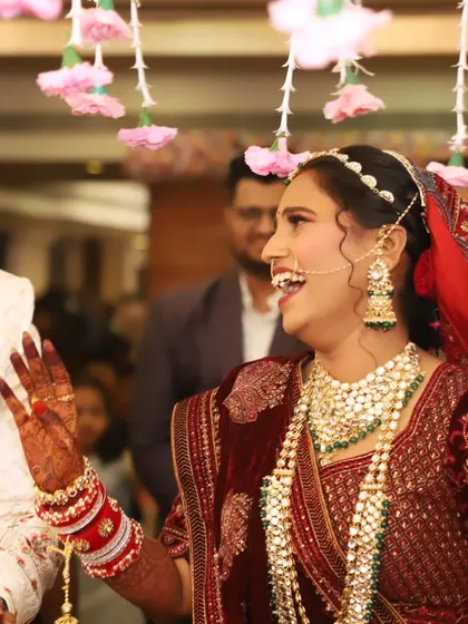 A close-up of the bride's joyful expression, her intricate jewelry and flawless makeup on full display.