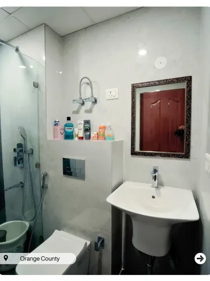 A simple and clean bathroom design with white tiles and chrome fixtures. The pedestal sink is a great choice for smaller spaces, making the room feel more open.
