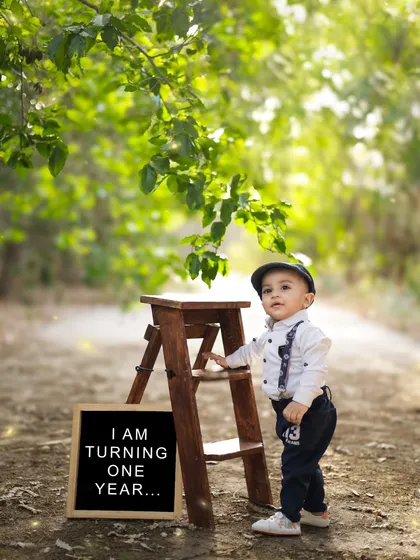 Standing tall and proud next to his birthday sign. We capture a variety of poses during our outdoor sessions, from sitting and playing to standing and exploring.