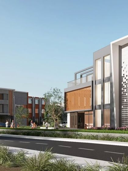 An alternate street view of the KPS School campus, highlighting the different building blocks and their relationship to one another. The composition uses a mix of solid volumes, glass facades, and textured panels to create a dynamic and contemporary look for this institutional building.