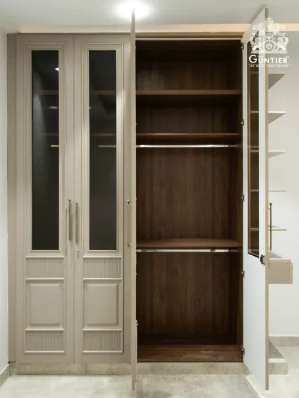 A glimpse inside the classic wardrobe design, showing the rich, dark wood interior that contrasts beautifully with the lighter exterior.