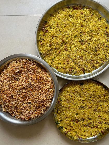 Large thalis filled with different varieties of homemade chivda, a classic Indian savory snack mix.