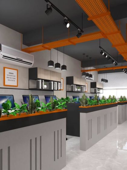 We designed these workstations with biophilic principles, integrating planters to improve air quality and employee well-being. The industrial-style exposed orange ducts add a pop of color and character.