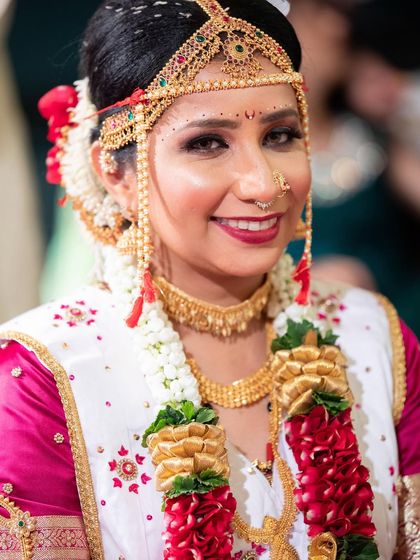 A beautiful bride ready for her wedding. This traditional look features a classic red lip and authentic jewelry.