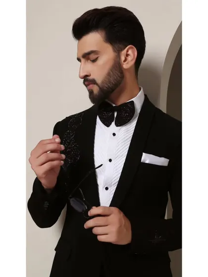 A close-up of the Galaxy tuxedo. The design features sleek black-on-black beadwork on the shoulder, evoking the quiet mystery of the cosmos. It's a subtle detail that adds immense character.