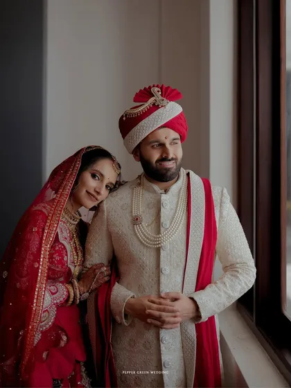 A quiet, tender moment as the bride rests her head on the groom's shoulder, a beautiful portrait of love and trust.
