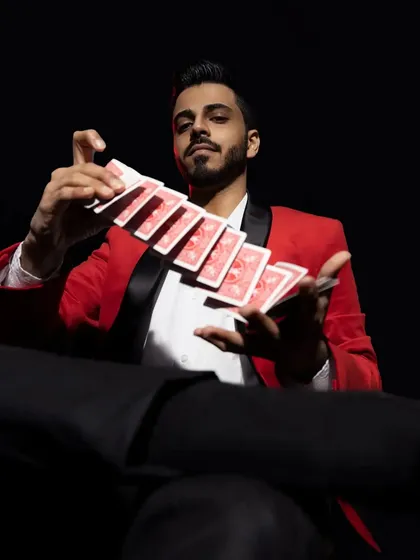 A cool shot of me in a red blazer, performing a card flourish. This is all about unlocking the secrets of the mind, one card at a time.