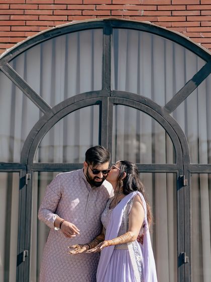 A sweet kiss on the cheek, a simple and heartfelt expression of love during their pre-wedding photography session.