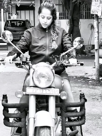 A black and white shot of a graduate, focused and determined. This artistic photo captures the timeless spirit of a rider.