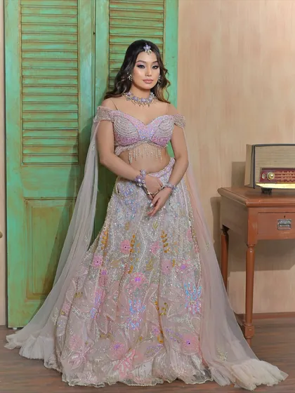 A full-length view of the pastel lehenga, showing how the lilac floral jewellery creates a cohesive, fairy-tale look.