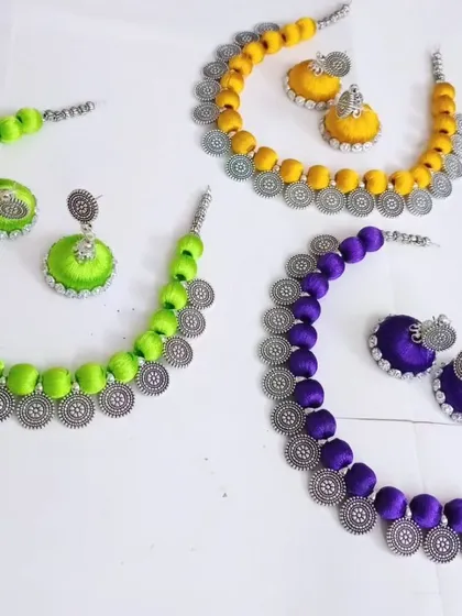 When a customer wanted Holi colors, we created these custom silk thread necklace sets. This image shows them in vibrant neon green, turmeric yellow, and deep purple.