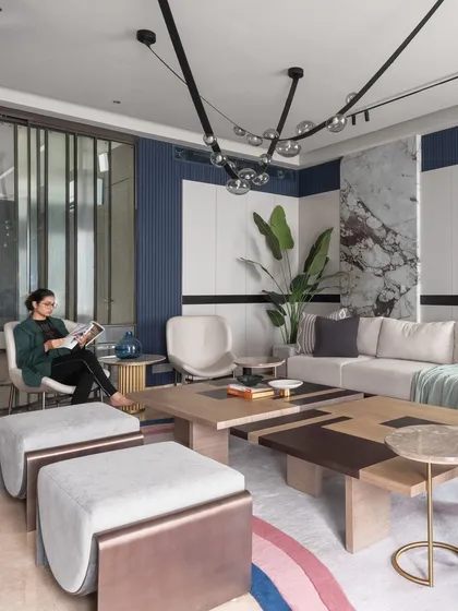 In our modern loft project, we mixed various materials to create a luxurious feel. The space features a split-level coffee table, bold blue wall paneling, and a statement marble accent wall for a sophisticated look.