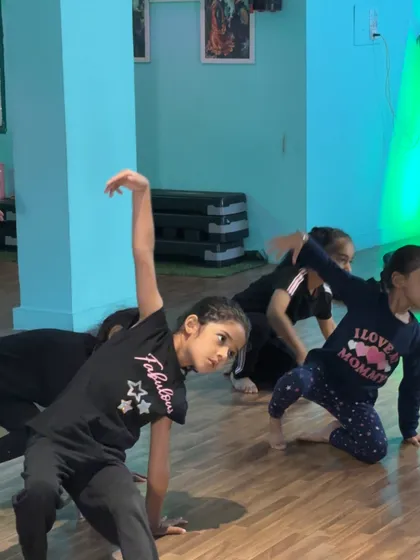 Students in our Contemporary Beginners class practicing their poses. There's a mix of intense focus and joyful energy in every session.