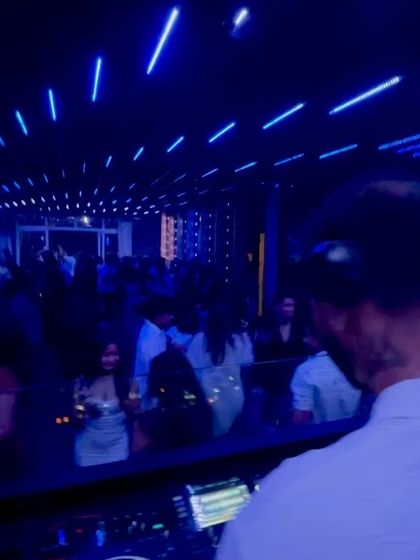 A serene moment under the blue lights, but the energy is still simmering, ready for the next drop.