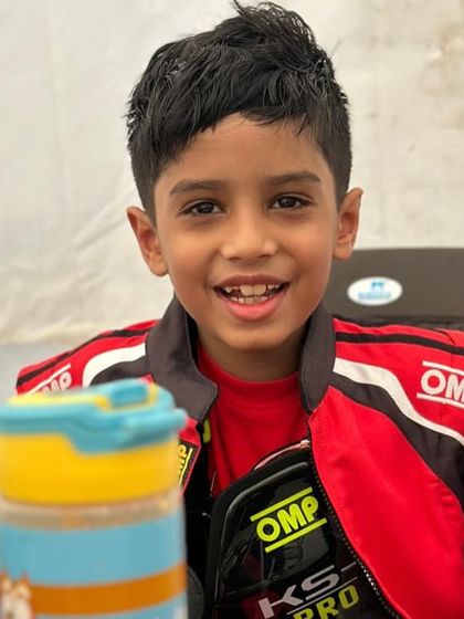 A happy young driver in the pits.