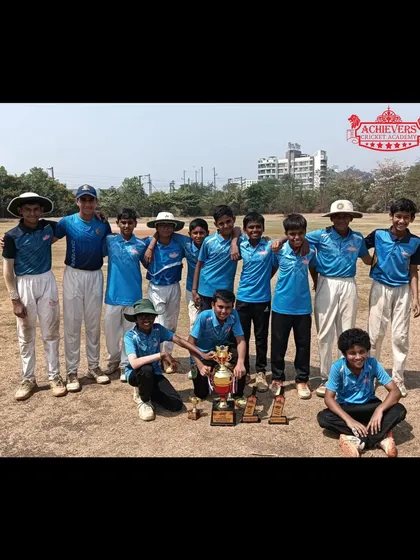 The U-14 team posing with the AT Cup Mini IPL trophy, a culmination of their excellent performances.