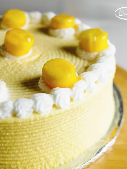 A close-up of the delicate piping and fresh mango topping on our seasonal Mango Cake. Every detail is crafted to make your dessert experience special.