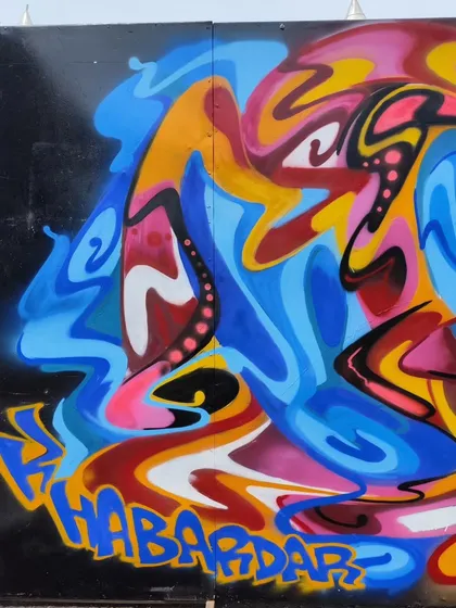 A section of the Jakarta mural, showing the word 'Khabardar' hidden within the abstract flow.