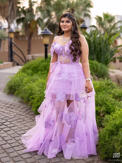 A full-length shot showing how the soft, romantic makeup completes her modern fairytale look for the sundowner.