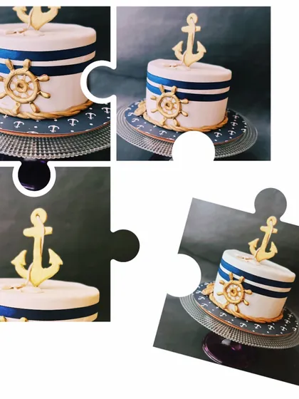 A charming nautical-themed cake with a golden anchor and ship's wheel, ideal for a sailor-themed party or baby shower.