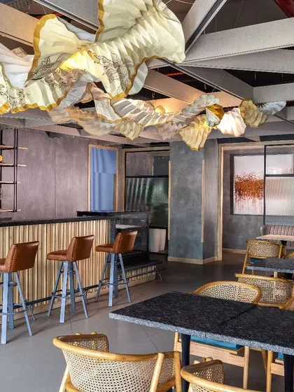 The cafeteria at Paras Healthcare features another incredible origami installation, this one inspired by the Kasavu sarees and banana leaves of Kerala. This piece serves as both a light fixture and a medium for storytelling, celebrating nourishment and wellness.
