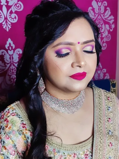 For those who love a bit of drama, I enjoy creating bold, glittery eye makeup. This close-up shows a vibrant pink and purple cut-crease eyeshadow look, perfect for an engagement or a sangeet night.