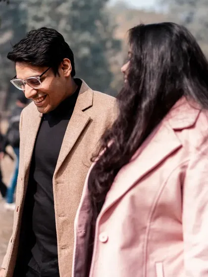 A casual stroll through the park, filled with smiles. This captures the simple, everyday happiness that is the foundation of a great love story.