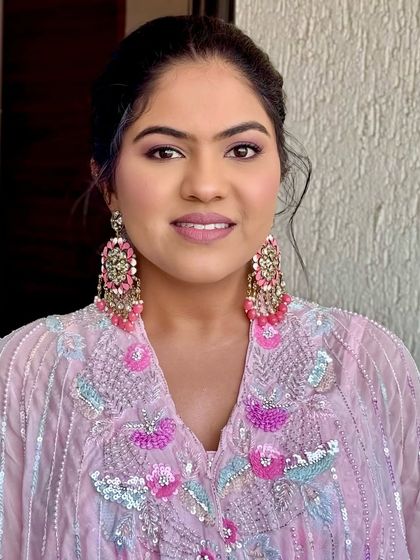 A smiling portrait showing off the soft and elegant glam. This makeup is designed to feel light and look fresh, perfect for a daytime celebration.