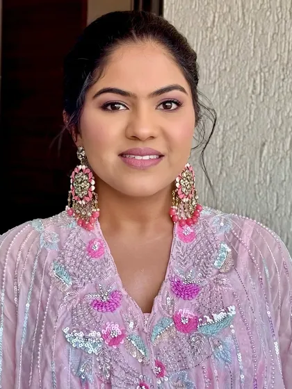 A smiling portrait showing off the soft and elegant glam. This makeup is designed to feel light and look fresh, perfect for a daytime celebration.