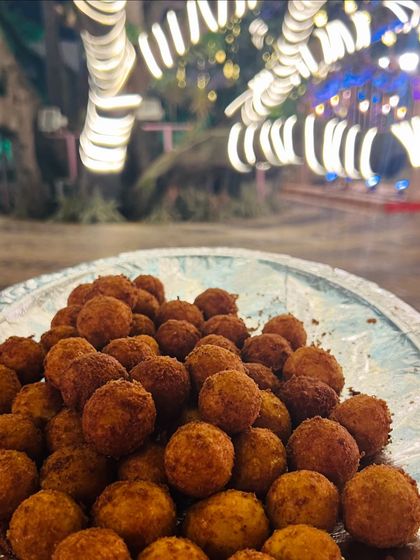 Crispy Cheese Balls served fresh and hot. These are a classic comfort food and an absolute favourite at parties, especially with an evening lights backdrop.
