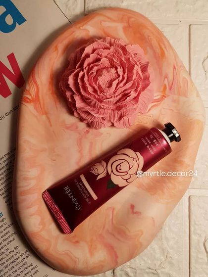 A top-down view of the pink and orange marbled tray. The gentle, cloud-like shape is one of our signature designs.