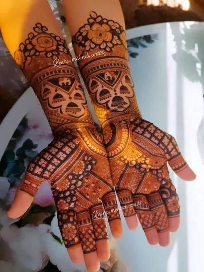 A beautiful example of a full bridal design with a rich, warm stain. The sunlight catches the intricate details, showing the depth of the pattern which includes checks, florals, and paisleys.