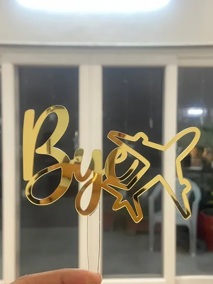 A fun "Bye Bye" topper with an airplane motif, perfect for a farewell party.