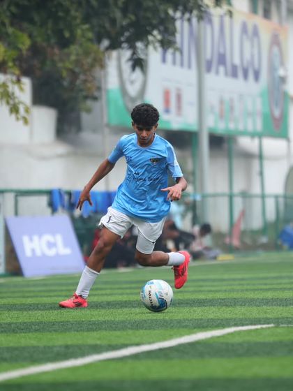 Every move is a step closer to greatness. A player skillfully dribbles down the wing, looking to create a scoring opportunity.